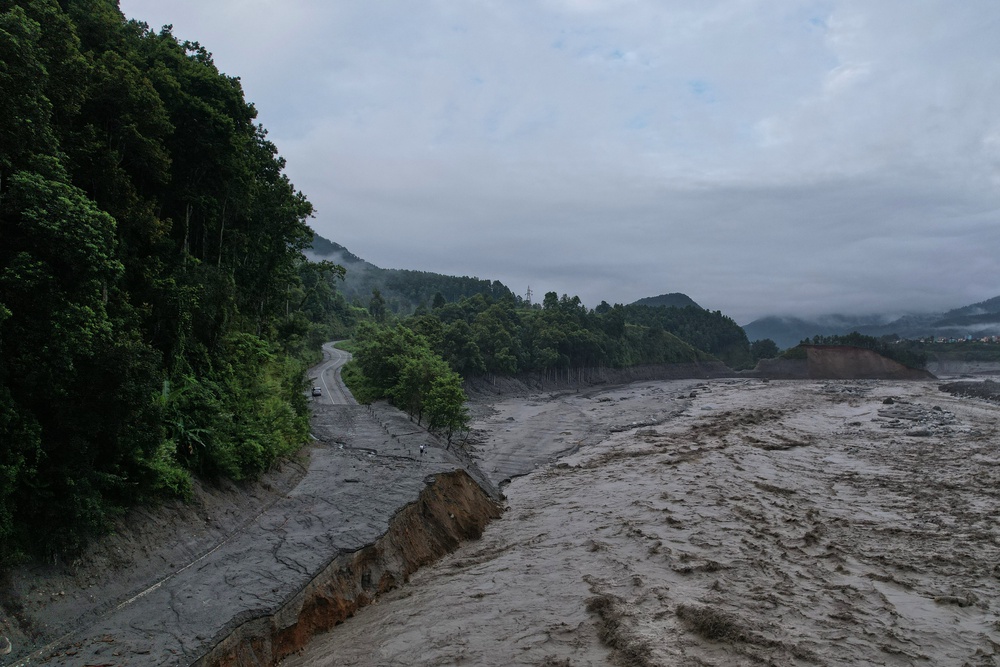 A drone view shows a major section of Pasang Lhamu highway washed away along swollen Trishuli river by recent flash floods cutting off Rasuwa district from Nuwakot area, Nepal, Monday, 31 August 2026 (AP)