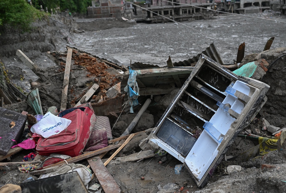 Household belongings lie scattered in mud (Getty)
