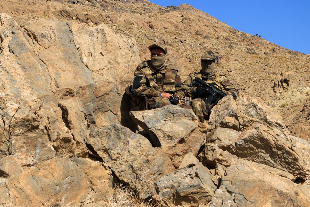 Afghan security personnel sit guard at the inauguration ceremony of an iron ore mine, at Ghorian district in Herat province (AFP/Getty)