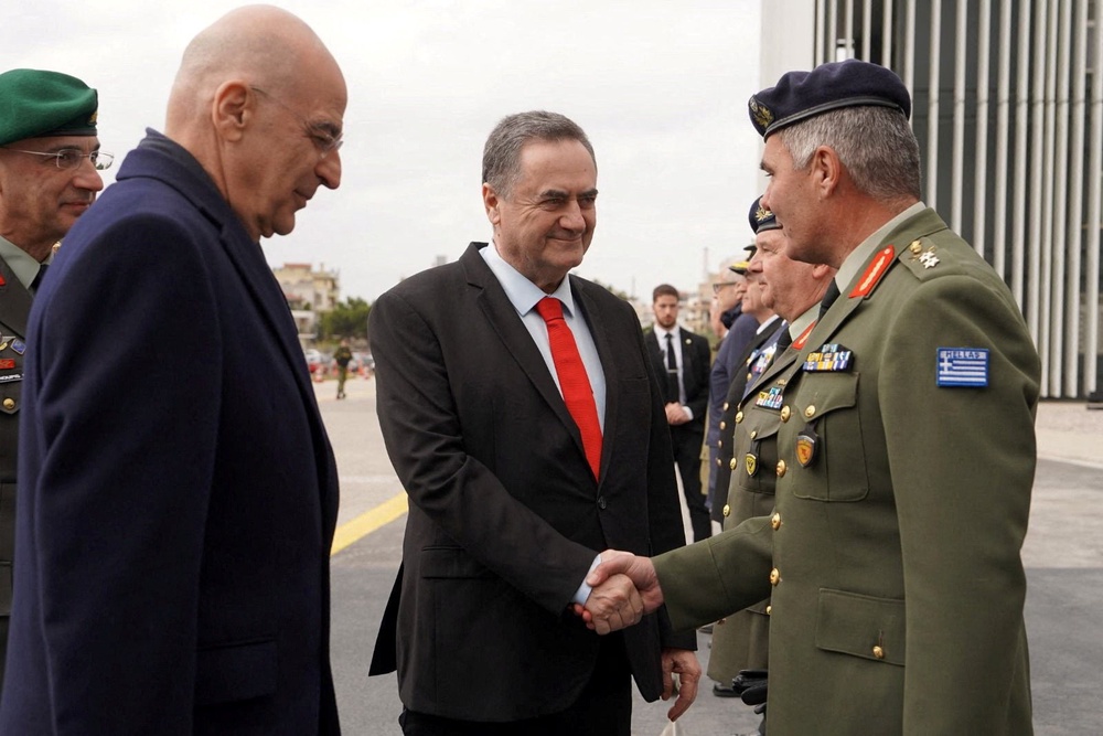 Israel Defence Minister Israel Katz shakes hands with General Director of the General Directorate for Defence Investments and Armaments (GDDIA) of Greece, Major General Ioannis Bouras, next to Greece's Minister for National Defence Nikolaos Dendias, during a visit in Greece on January 2026 (Reuters)