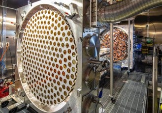 Photomultiplier tubes to capture light from particle interactions (PA)