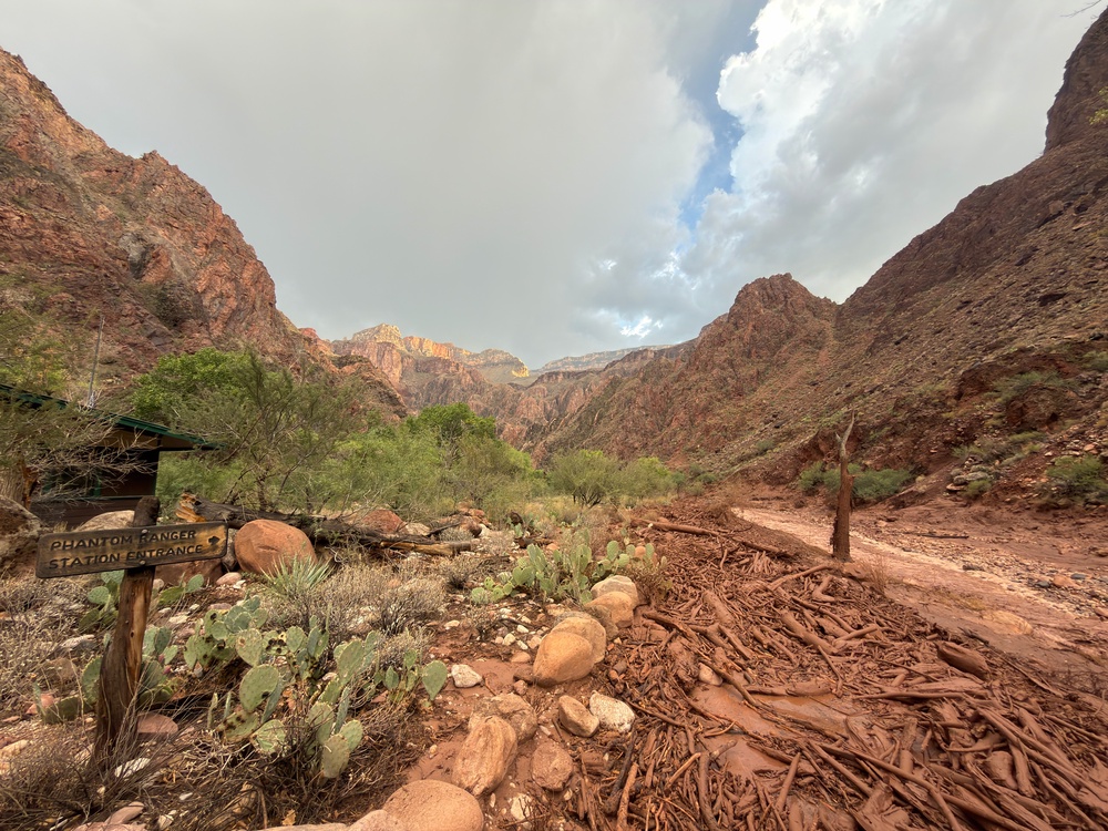 Debris in a flooded Bright Angel Creek is seen near the historic Phantom Ranch Lodge in Arizona’s Grand Canyon on Saturday afternoon (AP)