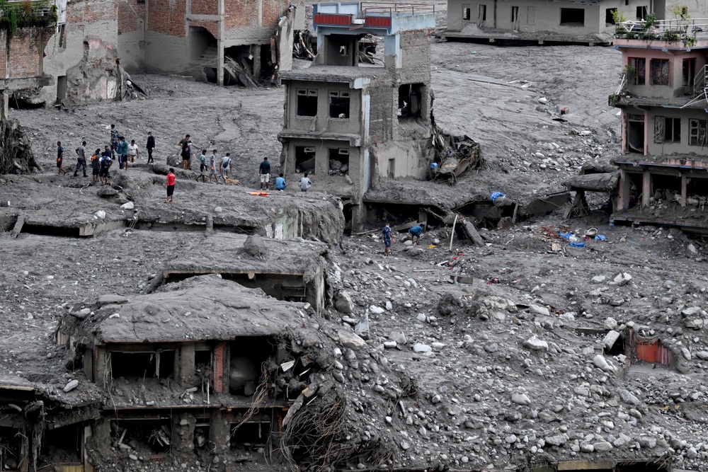 People scout for usable materials from debris after flash floods at Trishuli Center in Nepal's Nuwakot district on September 1, 2026 (AFP/Getty)