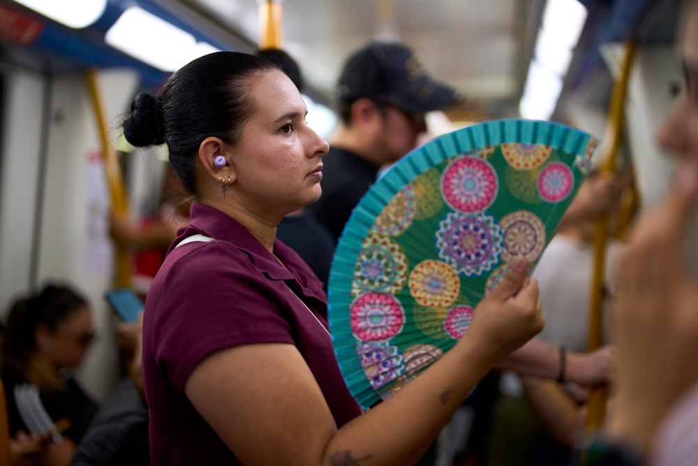 A woman uses a fan to cool herself on the subway in Madrid, Spain. (Copyright 2026 The Associated Press. All rights reserved.)