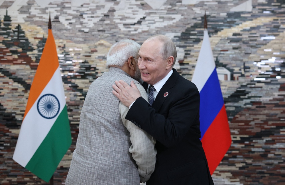 Vladimir Putin and Narendra Modi greet each other during a meeting on the sidelines of the Shanghai Cooperation Organisation (AFP/Getty)