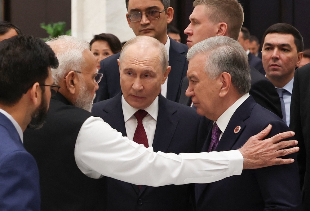 Indian prime minister Narendra Modi, Russia’s president Vladimir Putin and Uzbekistan’s president Shavkat Mirziyoyev interact as they arrive for a reception in honour of participants in the Shanghai Cooperation Organisation (SCO) summit (AFP/Getty)