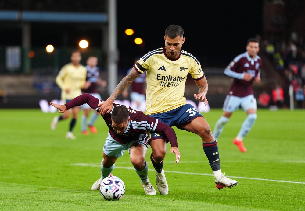 Aston Villa's Emi Buendia and Arsenal's Bruno Guimaraes battle for the ball (PA)