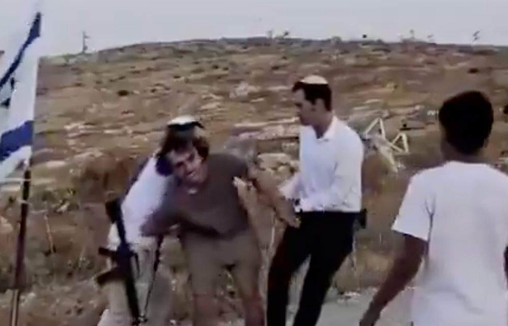 Footage shows Joughin’s arms being wrestled behind his back (Social media)