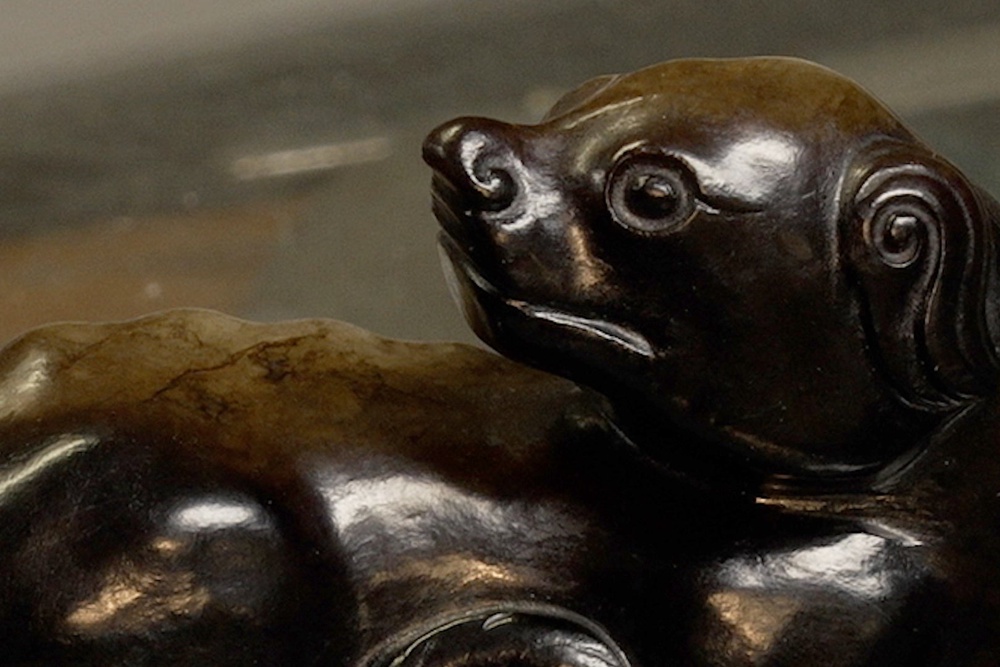 The animal, measuring 8.5cm long and made of the mottled black and green stone, was carved in a recumbent position with its head turned back and tail and legs curled up (Phil Barnett)