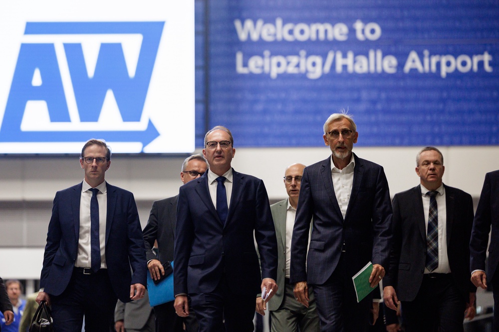 Alexander Dobrindt (centre left) arrive for a news conference at Leipzig/Halle Airport on Tuesday (Getty)
