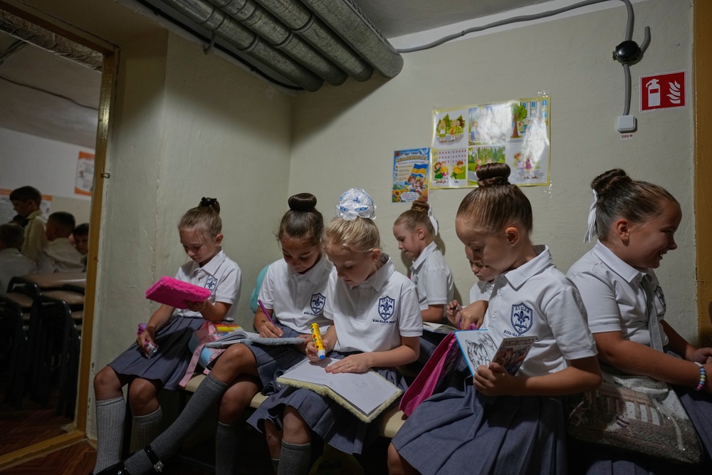 Schoolgirls work on a lesson in a bomb shelter during a Russian air attack on the first day at school at a cadet lyceum in Kyiv, Ukraine, Tuesday, Sept. 1, 2026. (AP Photo/Efrem Lukatsky) (Copyright 2026 The Associated Press. All rights reserved)