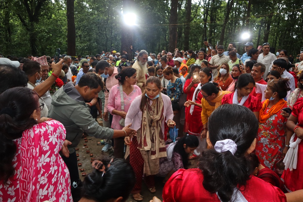 People gathered to light candles and pray for the victims of flash floods at the site of a mass burial in Chitwan, Nepal (AP) (AP)