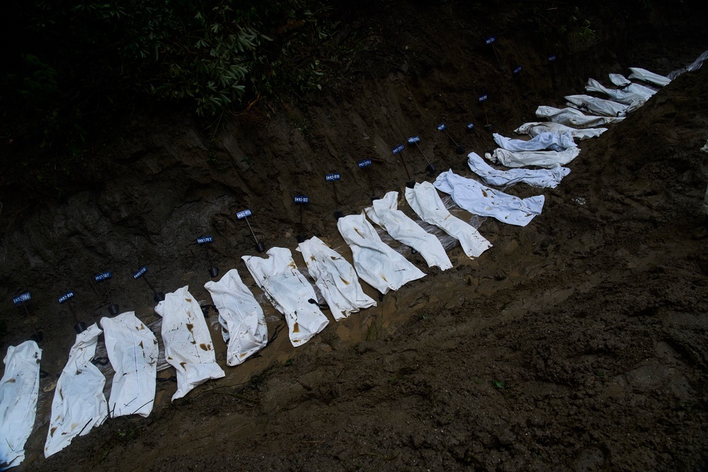Bodies of the victims of the flash floods are prepared for mass burial in Kathmandu, Nepal (AP)