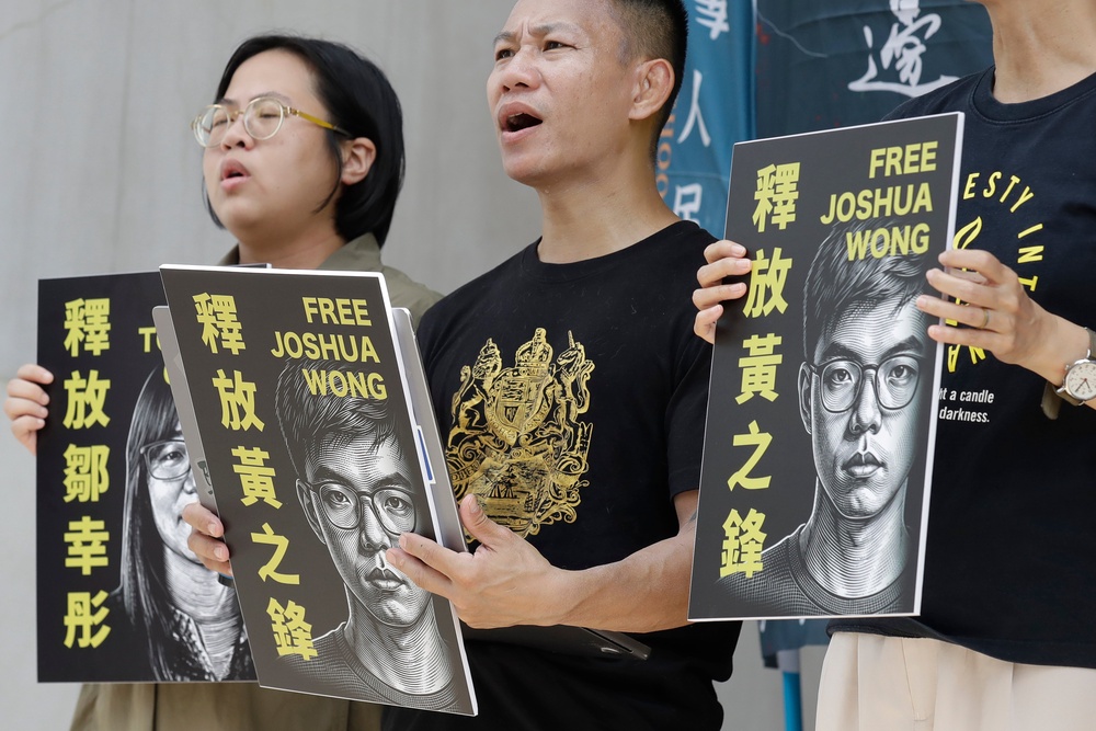 Hong Kong activist and supporters hold signs during a press event to support pro-democracy activist Joshua Wong in Taipei, Taiwan, Wednesday, 2 Sept 2026 (AP)