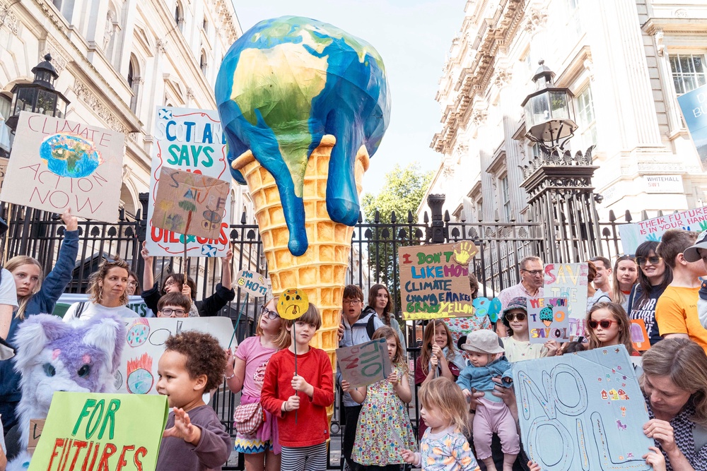 A giant melting-planet ice cream is displayed outside 10 Downing Street as Mothers Rise Up calls for urgent heat adaptation, clean energy and an end to new North Sea oil and gas (Denise Laura Baker / Mothers Rise Up)