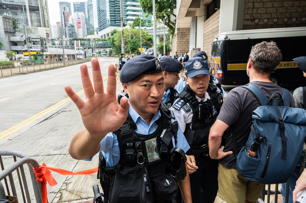 Police officers stand guard outside the High Court in Hong Kong, Wednesday (AP)