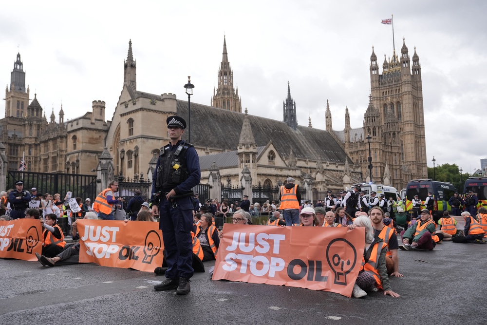 Just Stop Oil activists took part in a demo outside the Houses of Parliament, demanding that the UK government stop approving all further oil and gas developments (PA) (PA Wire)