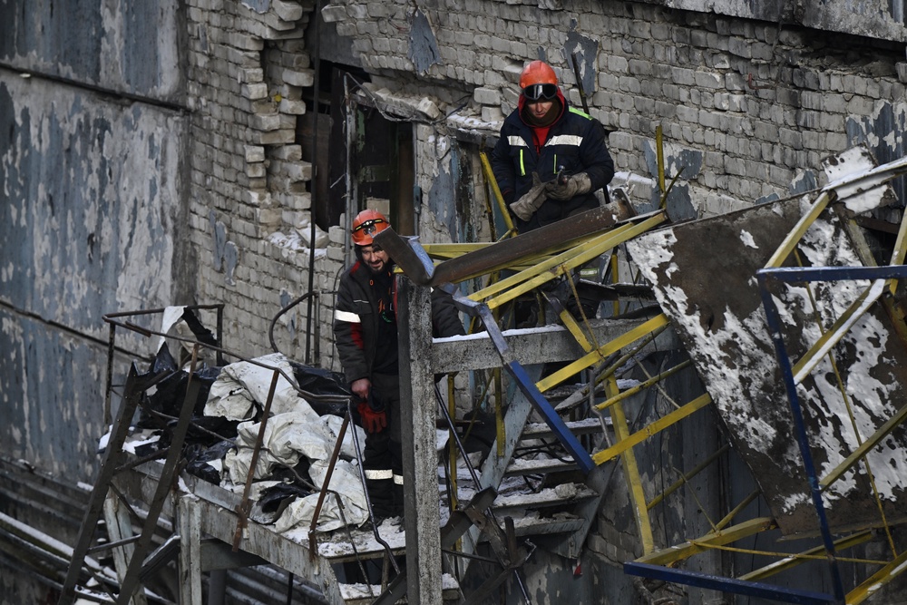 Employees clear debris at a heavily damaged thermal power plant in Ukraine following Russian missile and drone strikes (AFP/Getty)
