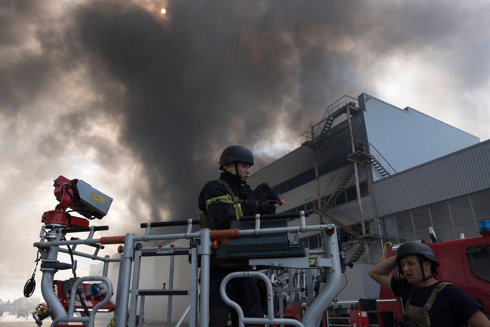 Ukrainian rescue personnel extinguish a fire in an auto parts warehouse following an air attack in Kyiv (AFP/Getty)