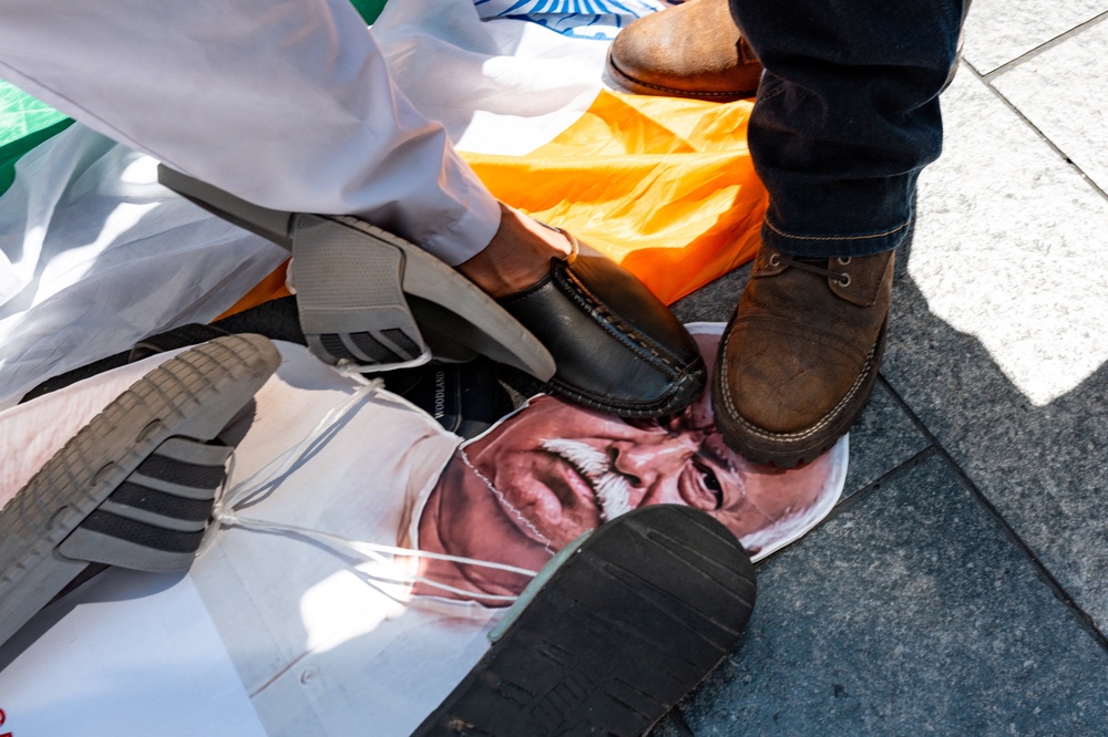 People stomp on a a cardboard cutout of Mohan Bhagwat during a protest against the RSS in New York City on 29 August 2026 (Reuters)