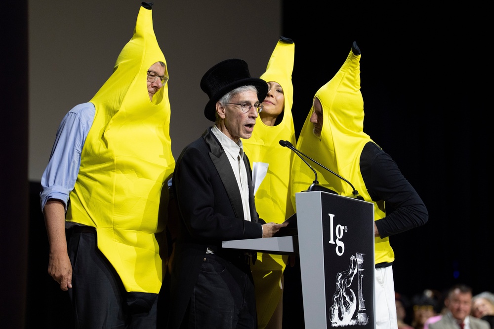 Marc Abrahams, editor of the Annals of Improbable Research, speaks surrounded by people dressed as bananas during the Ig Nobel Prize ceremony (AP)