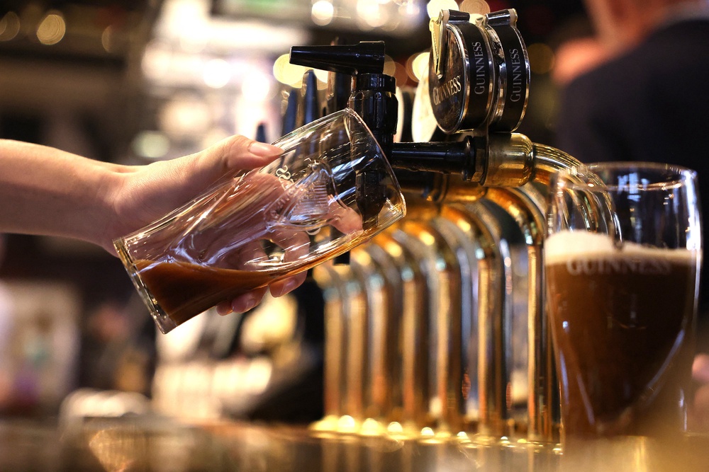 A bark worker pours a pint of Guinness at the bar in pub (AFP/Getty)