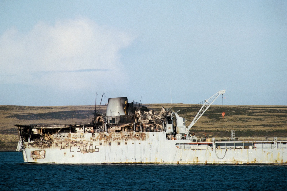 The damaged supply ship Sir Tristram lying off Bluff Cove in the Falklands after the Argentine air attack that led to the sinking of her sister ship, the Sir Galahad. 1 June, 1982 (PA)