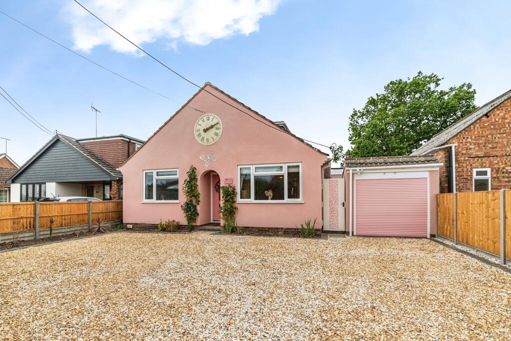 The front of the chalet style house is painted pink, including the garage and front door (Jam Press/Yopa, South East & London)