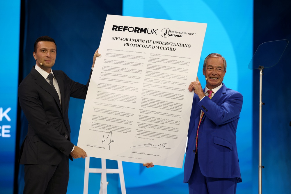 Reform UK Party Leader Nigel Farage (R) joins Jordan Bardella, President of National Rally on stage during the signing of a memorandum of understanding (Getty)