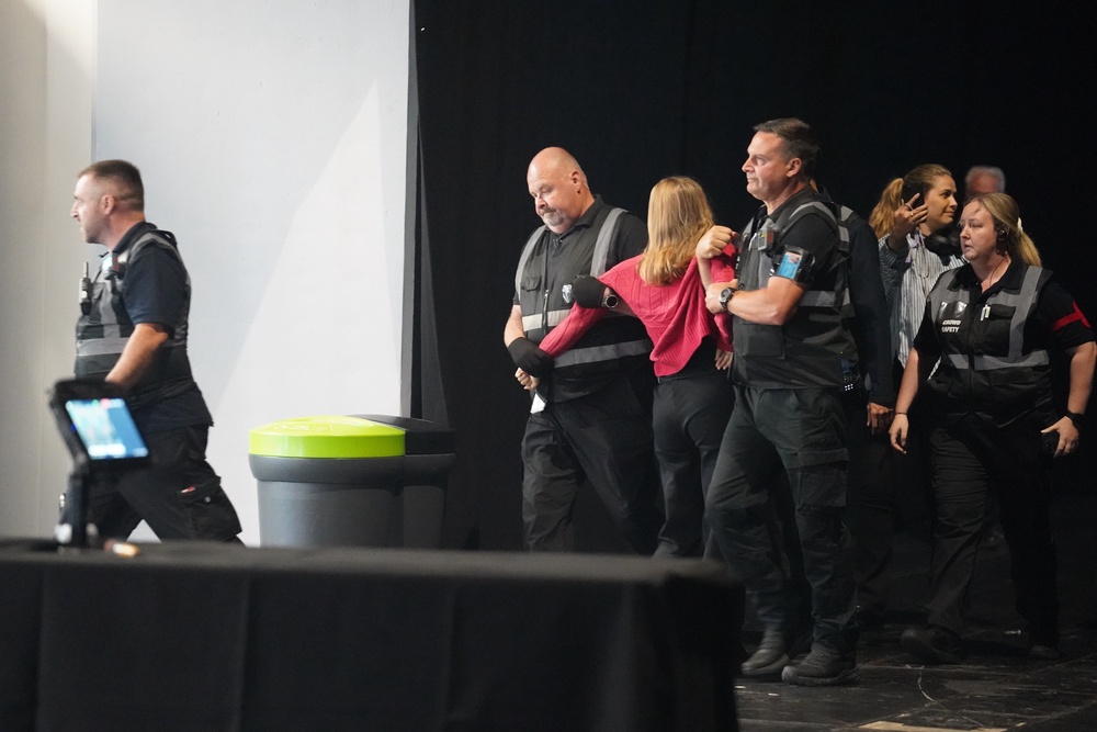 A heckler is removed (Joe Sene/PA) (PA Wire)