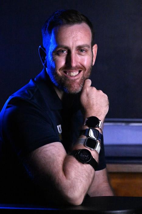 FIU researcher Jason Kostrna, wears the four smartwatches tested in his study. The watches include the Apple Watch Series 8, Fitbit Sense 2, Samsung Galaxy Watch 5 and Garmin Forerunner 955 (Taimy Alvarez/Florida International University)