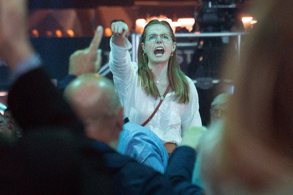 A demonstrator shouts while Reform UK leader Nigel Farage delivers a keynote speech (Stefan Rousseau/PA) (PA Wire)