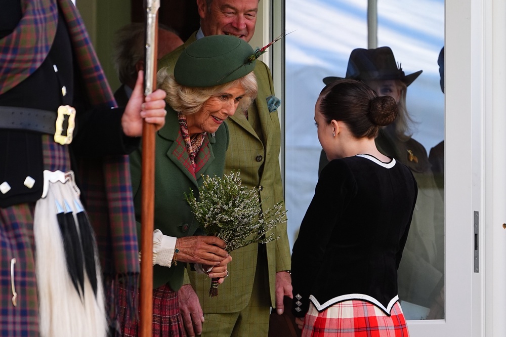 Camilla was presented with a bouquet by a highland dancer (Aaron Chown/PA) (PA Wire)