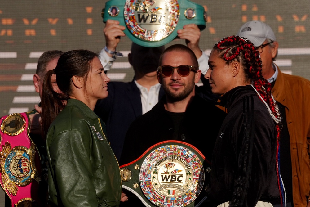 Katie Taylor (left) facing off with her final opponent, Flora Pili (PA)