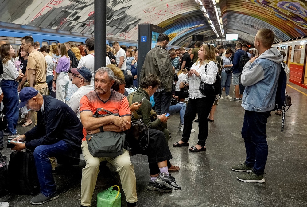 People wait for the end of the air raid alert and resumption of metro train service during a Russian drone attack (Reuters)