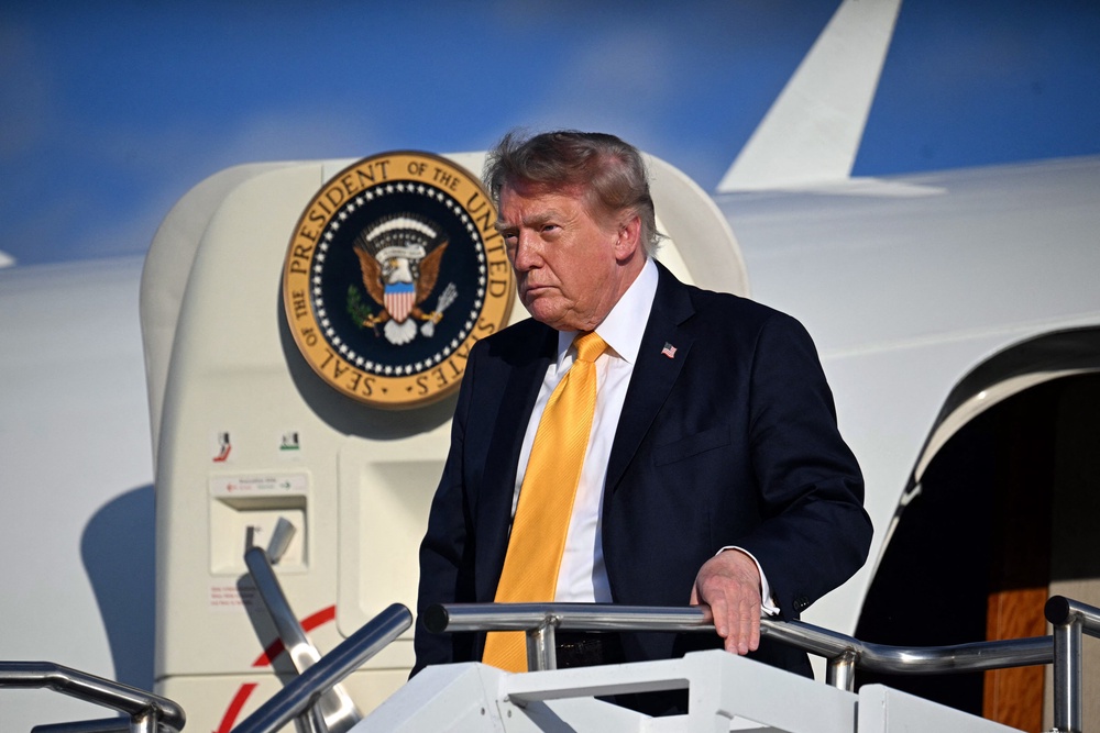 Trump was seen waving to reporters on the tarmac of an airport in Morristown, New Jersey, Friday, wearing a Navy suit and yellow tie — and, apparently, his new hairdo (AFP via Getty Images)