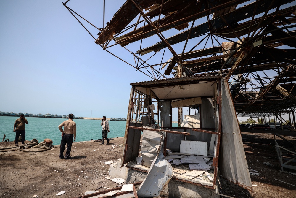Iranians gathered at the damage to the storage and warehousing facilities (AFP/Getty)