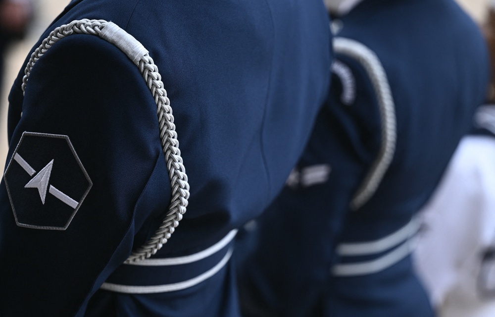 The new design includes a sleek, charcoal-colored collared jacket and pants compared to the current Navy blue uniforms (AFP via Getty Images)
