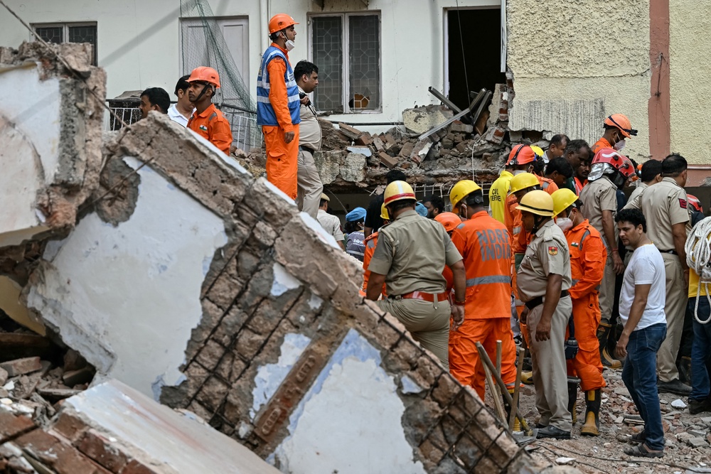 Rescue personnel conduct a search operation for survivors at the site of a building collapse in the Satya Niketan area in New Delhi on 6 September 2026 (AFP/Getty)
