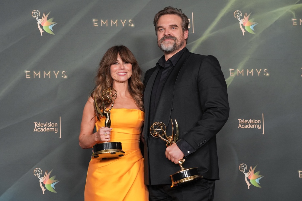 Linda Cardellini, left, and David Harbour pose in the press room with their awards (AP)
