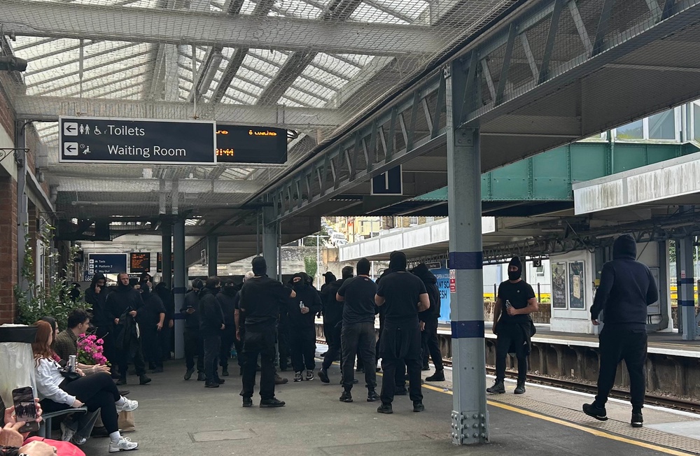 Protesters at Dover Priory train station after black-clad and masked anti-illegal migrant demonstrators blocked roads in Dover during a protest on Saturday (PA)