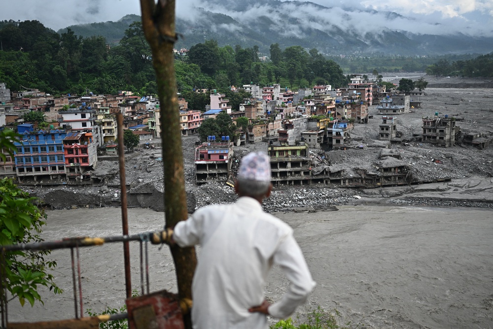 A man looks at the remains in the aftermath of flash floods at Trishuli in Nepal's Nuwakot district on 7 September 2026. - The 26 August glacial and mountain collapse on the China-Nepal border killed at least 1,398 people, with more than 5,500 missing, including around 800 foreigners (AFP/Getty)