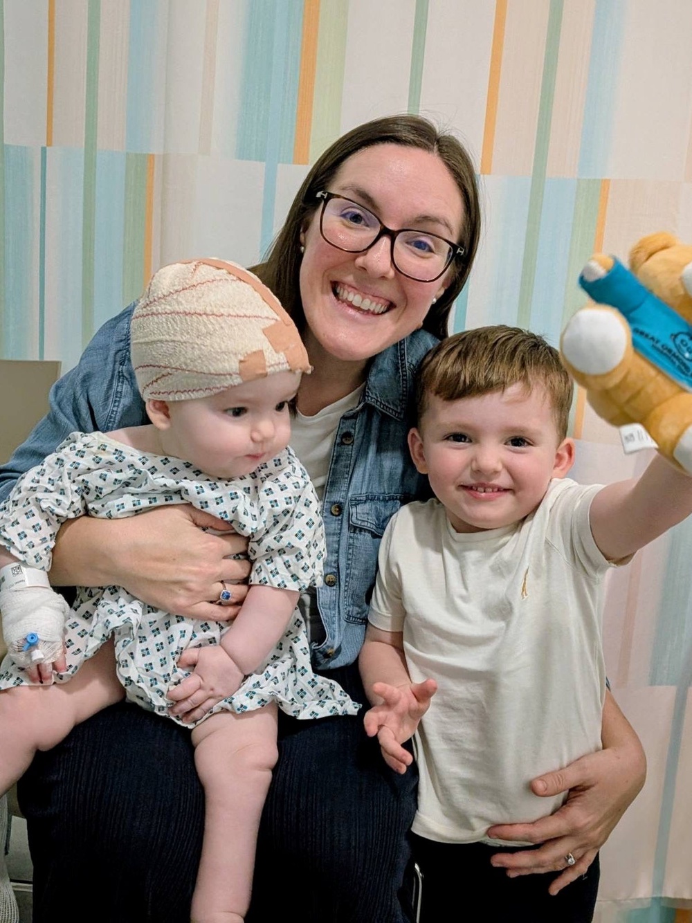One-year-old Rory, pictured with his mum Jo Potter and brother Oscar, was diagnosed with severe sagittal craniosynostosis (Family handout)