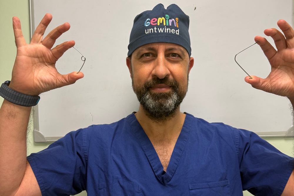 Professor Owase Jeelani, a consultant neurosurgeon at Gosh, holding the new ‘super elastic’ springs (GOSH)
