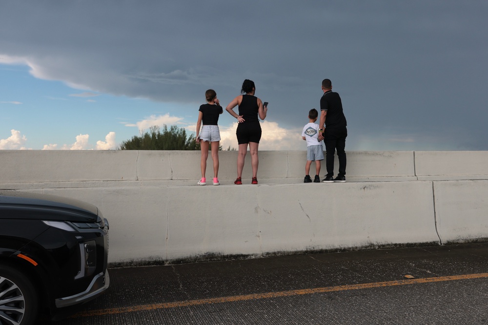 People stand on a median to look out at the wreckage caused by the crash (Getty)