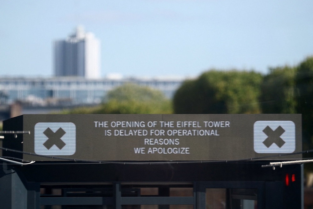 A sign reading 'the opening of the Eiffel Tower is delayed for operational reasons, we apologize' is seen at the Eiffel Tower in Paris, France, 7 September 2026 (Reuters)