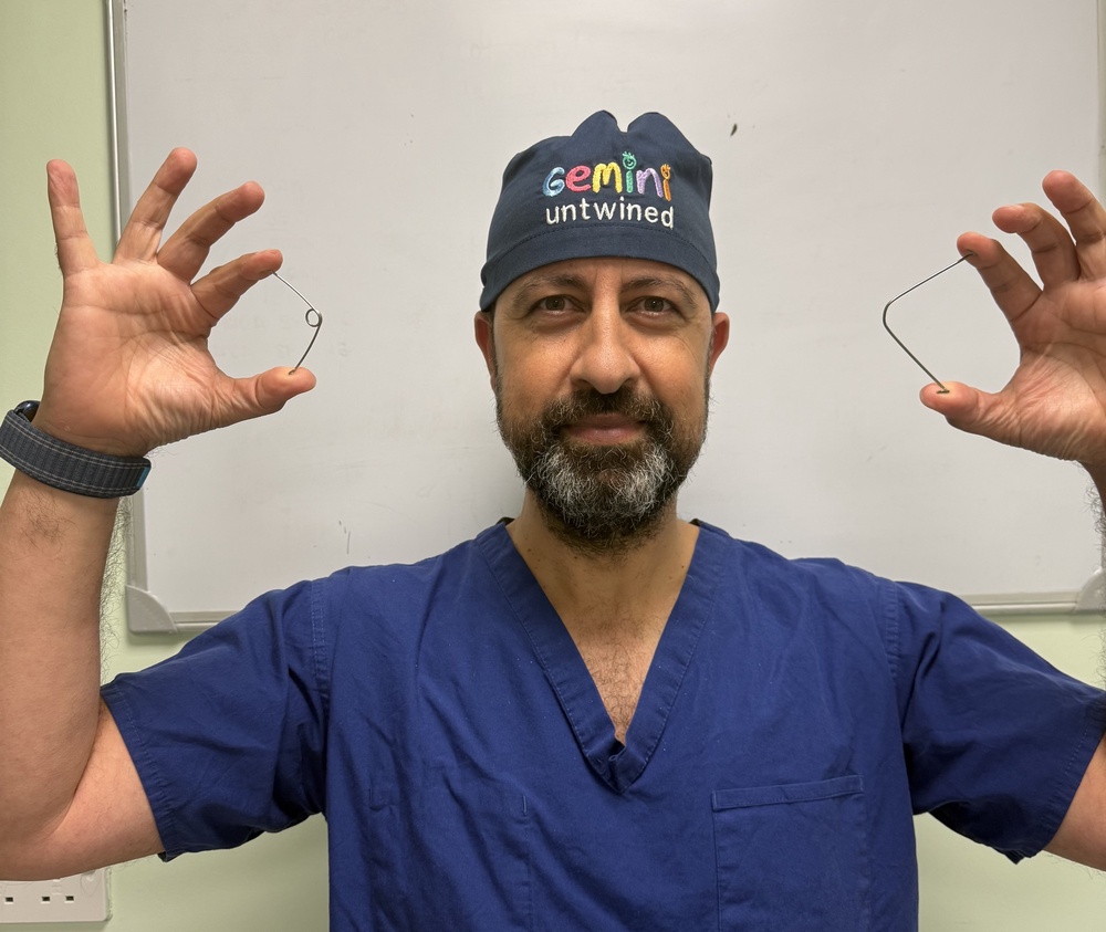 Professor Owase Jeelani, consultant neurosurgeon at Gosh holds the springs used to help Rory (Gosh/PA) (PA Media)