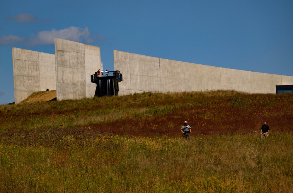 Visitors look over the crash site following the memorial ceremony at the Flight 93 National Memorial (Getty)
