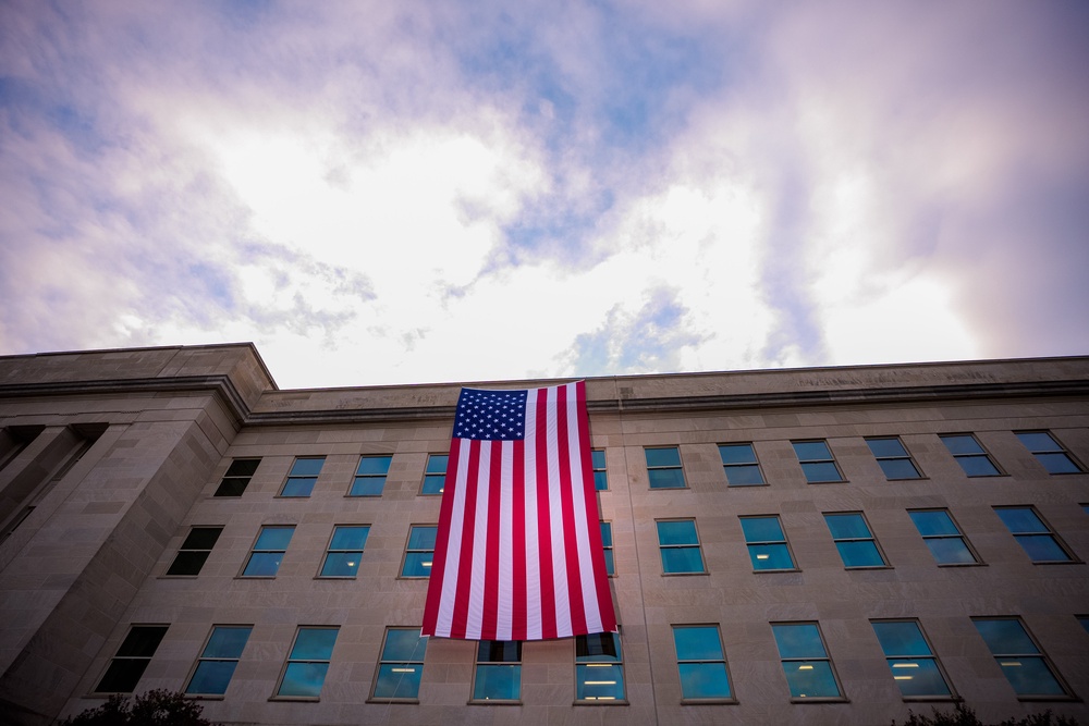 A large American flag after it is unfurled on the side of the Pentagon (Getty)