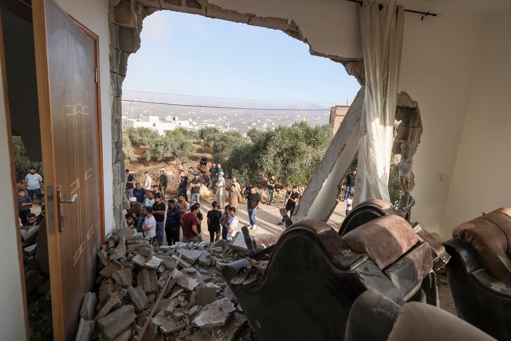 Palestinians inspect a family home destroyed by the Israel army following a military operation after a Palestinian man barricaded himself inside the house in the Israel-occupied West Bank village of Aqraba, south of the city of Nablus on September 8, 2026. (AFP/Getty)